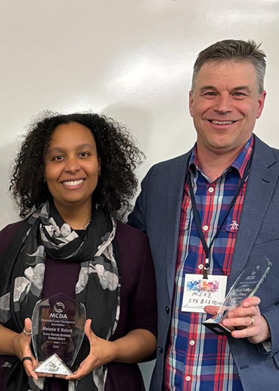Melanie Buford and Michael Stebleton pose with awards at MCDA