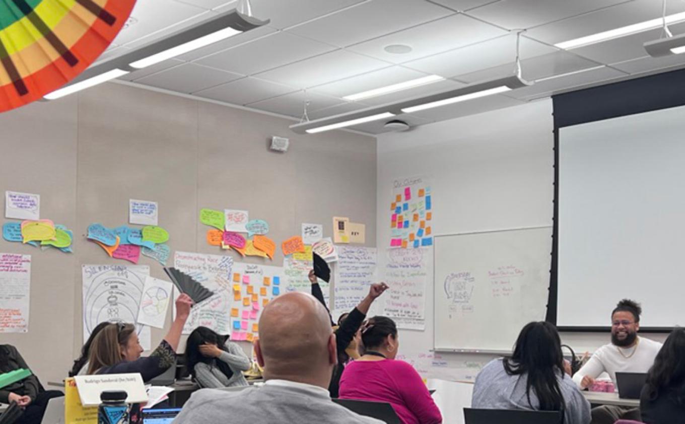 Nate Stewart facilitates a data equity simulation in a classroom of educators.